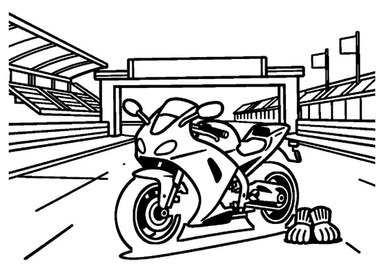 A modern racing motorcycle parked at the entrance to a karting or racing circuit.