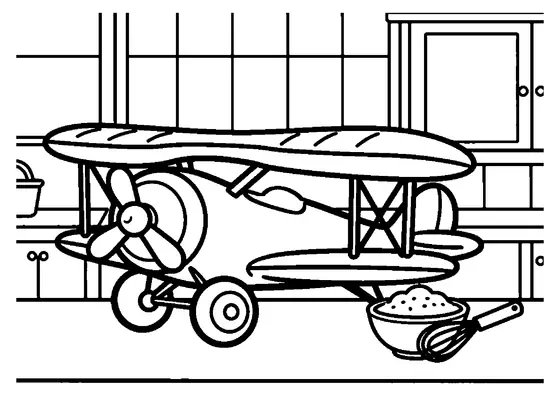 Avion biplan en pain d'épices avec une hélice posé sur un plan de travail à côté d'un bol de sucre glace.