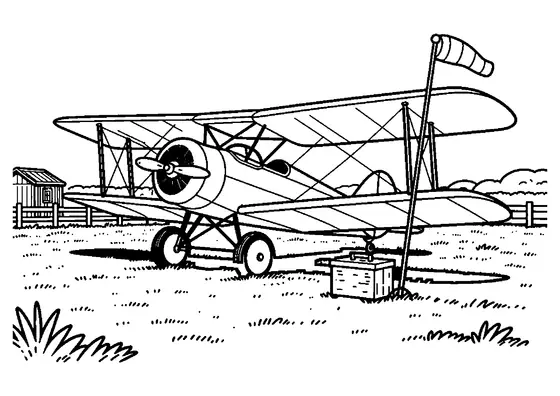 Un biplan clasic cu elice este parcat pe un aerodrom cu iarbă, lângă o mânecă de vânt.